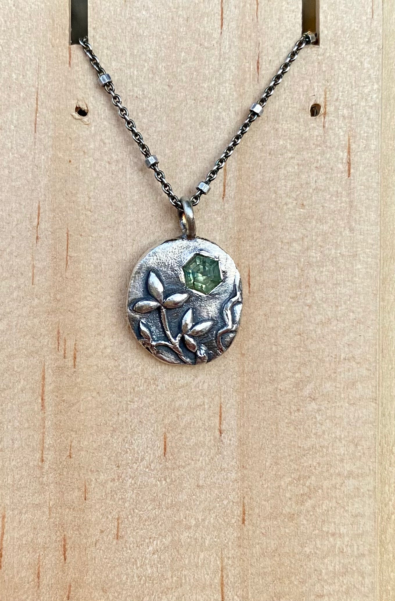 Sterling silver leaf necklace with hexagonal green sapphire on 16” chain